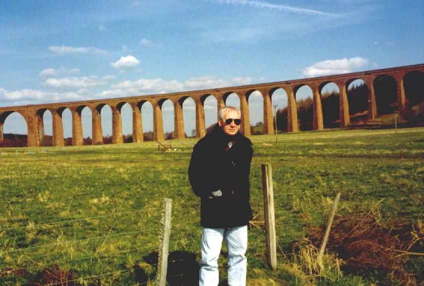 The Professor in front of a railroad bridge
